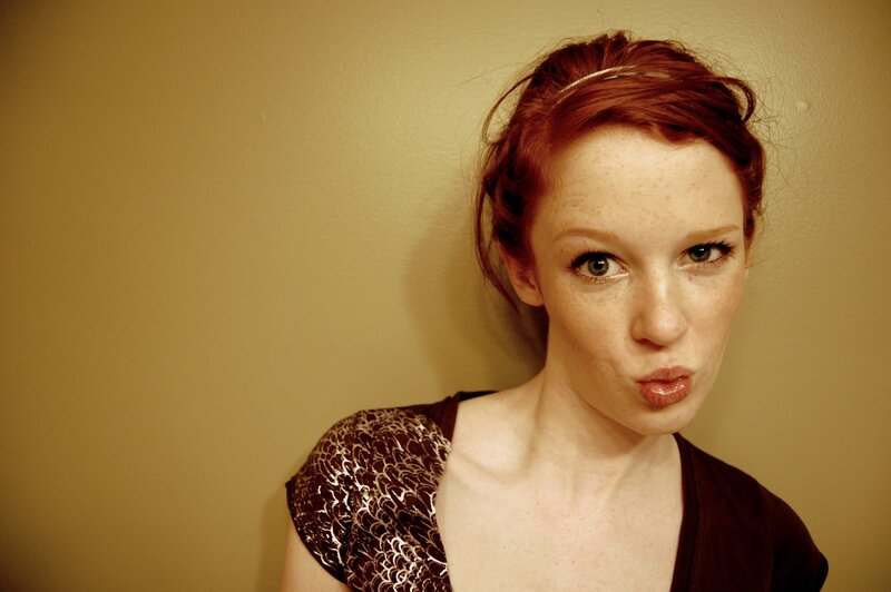 woman with red hair making a face