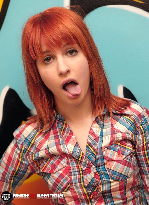 woman with red hair making a face