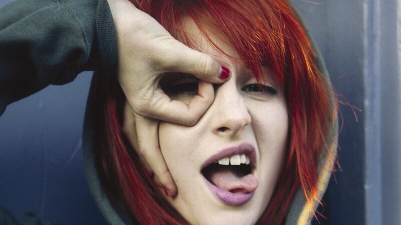 woman with red hair making face