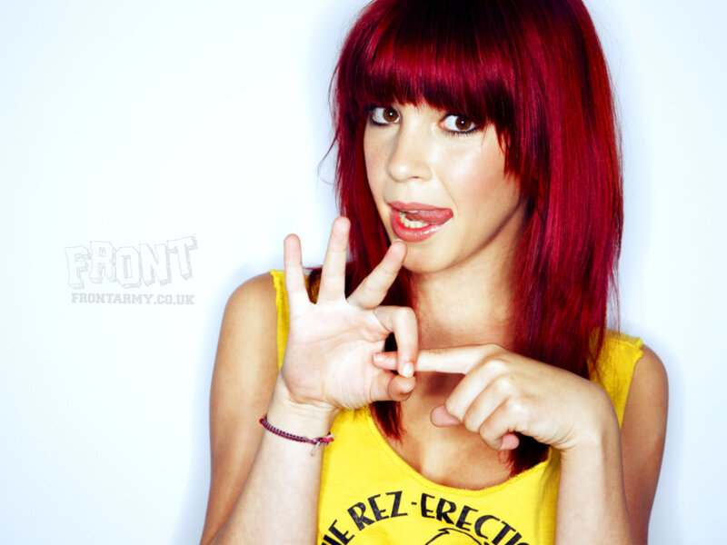 woman with red hair making hand gesture