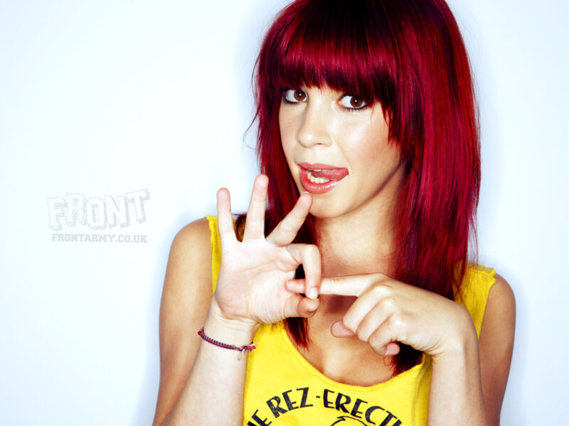 woman with red hair making hand gesture