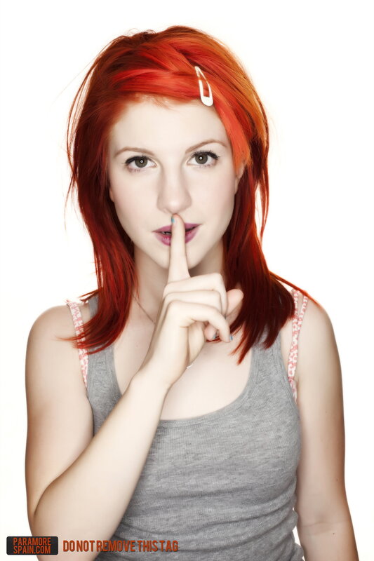 woman with red hair making shush gesture