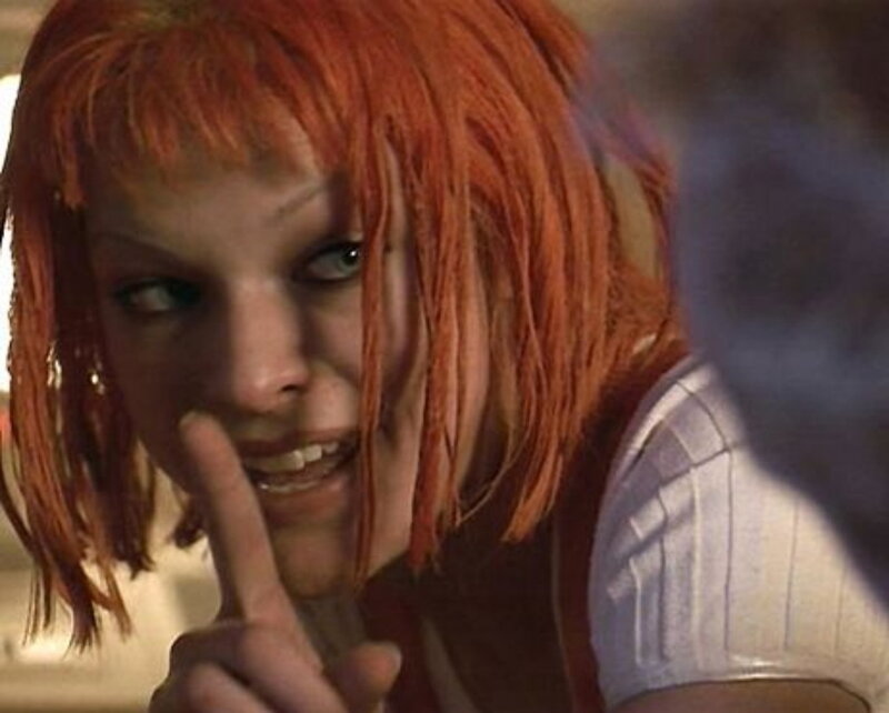 woman with red hair making shushing gesture