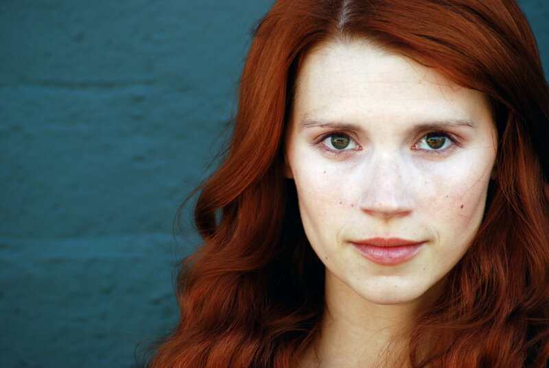 Woman with Red Hair — Neutral, Photograph, Green Eyes, Freckles, Blue Wall
