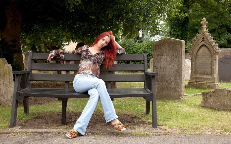 Woman with red hair on a bench