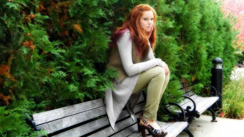 Woman with red hair on a bench