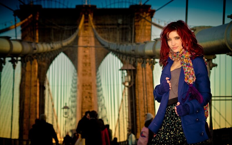 Woman with red hair on a bridge