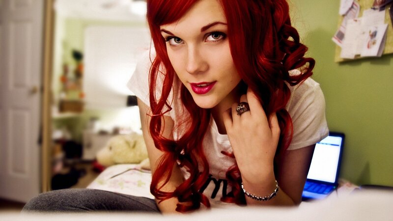 woman with red hair on bed