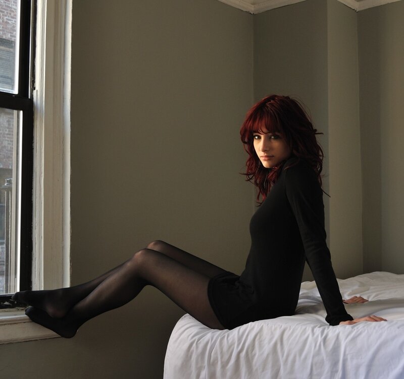 woman with red hair on bed