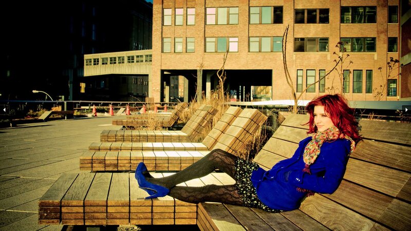 Woman with red hair on bench