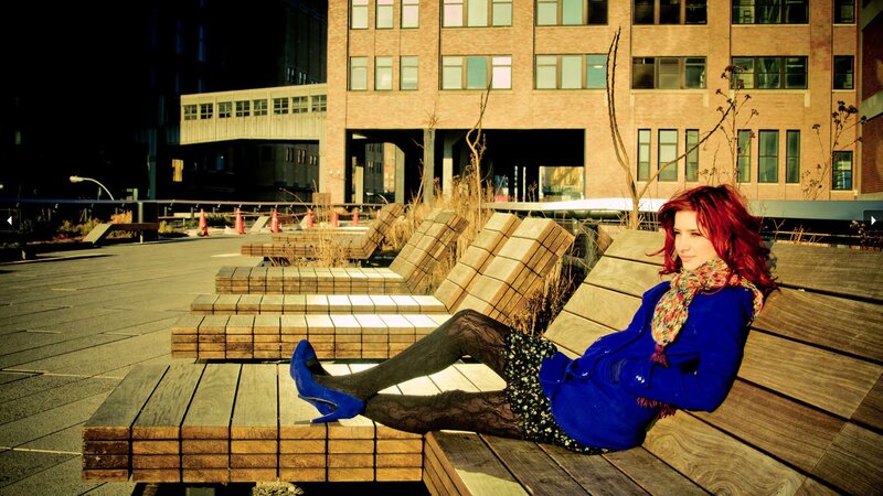 Woman with red hair on bench