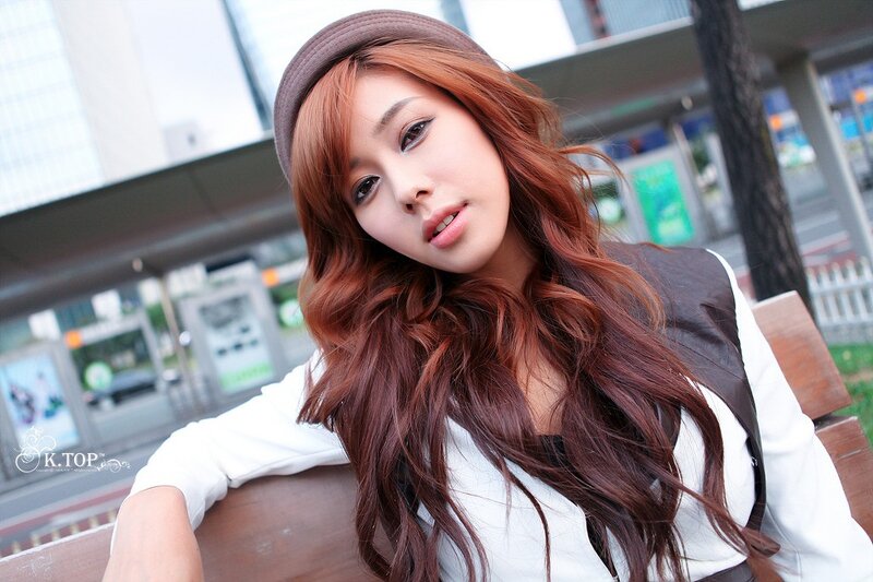 woman with red hair on bench