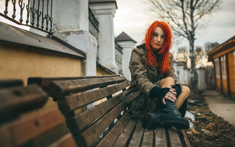 Woman with red hair on bench
