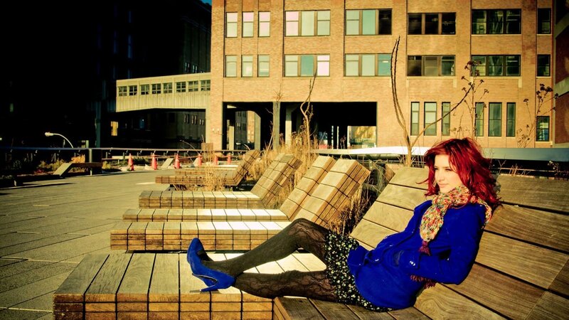 Woman with red hair on bench