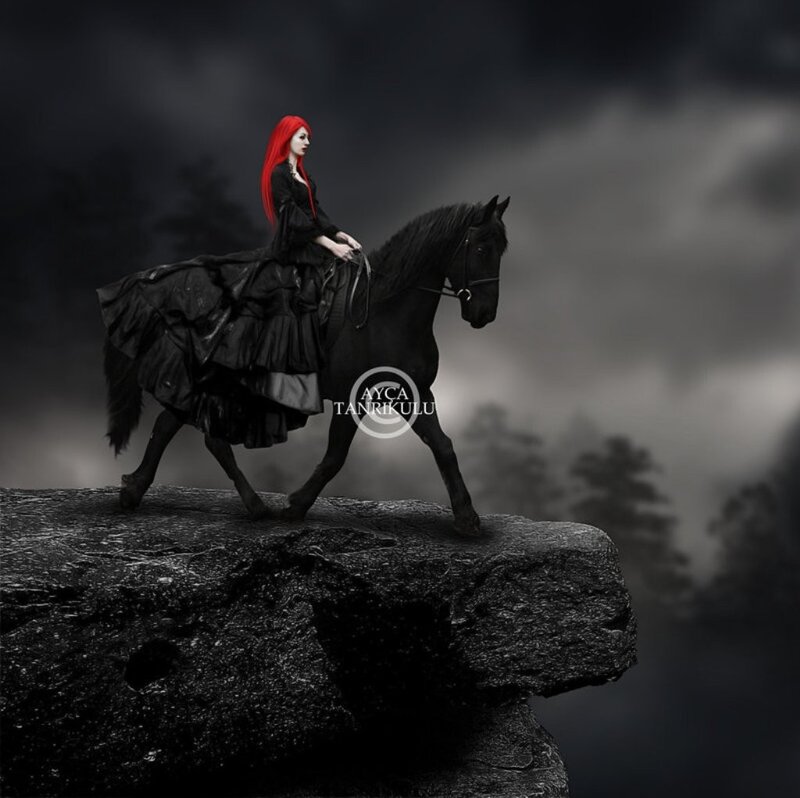 woman with red hair on black horse