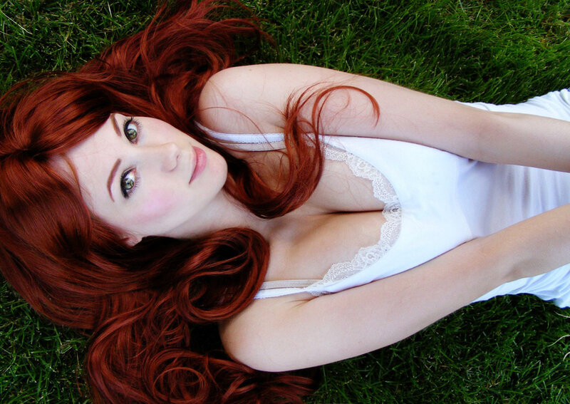 Woman with red hair on grass