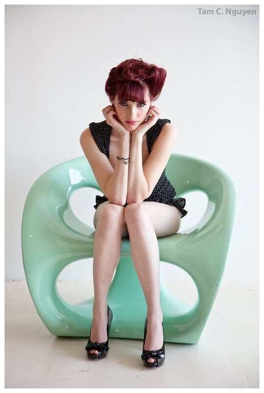 woman with red hair on green chair
