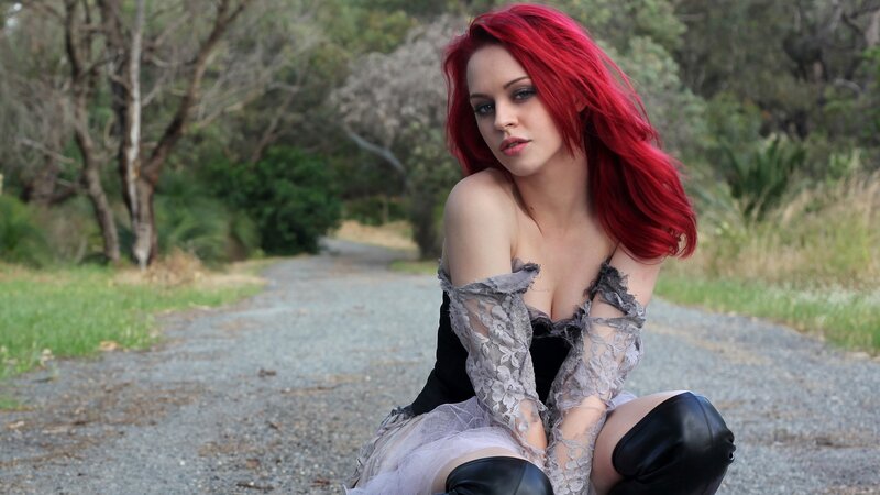 woman with red hair on path