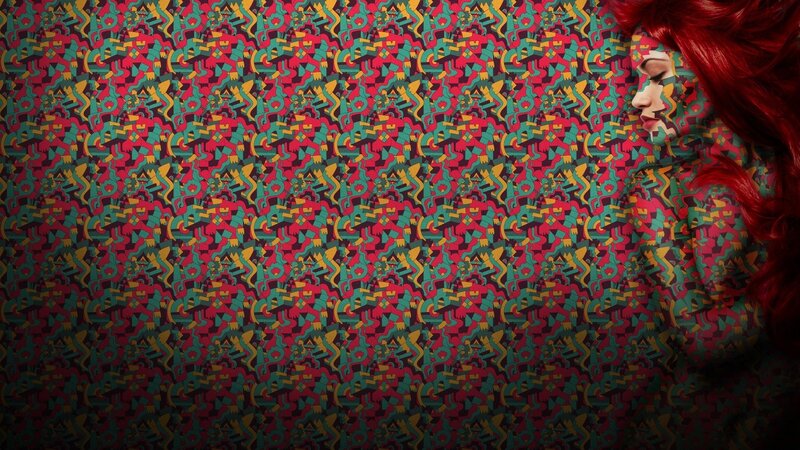 woman with red hair on patterned background
