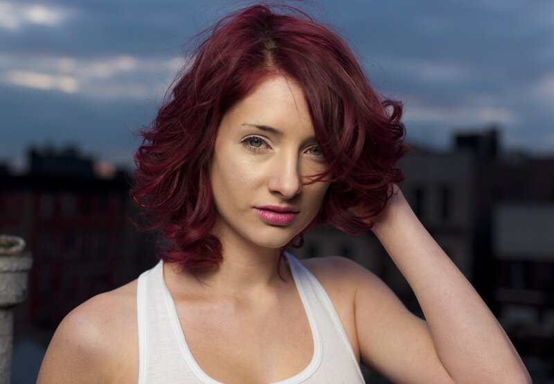 woman with red hair on rooftop