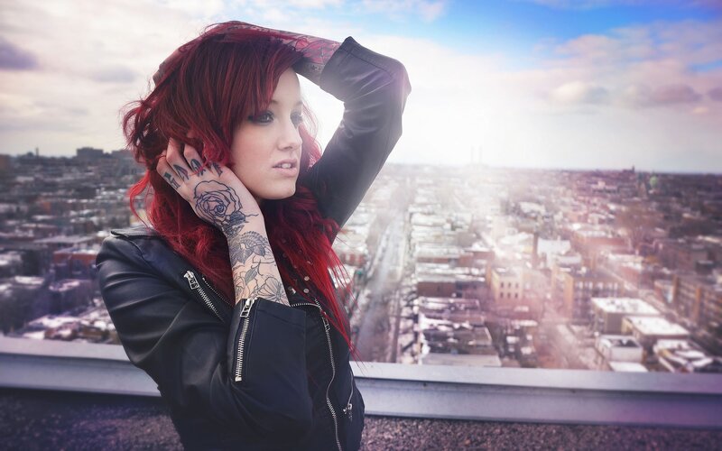 woman with red hair on rooftop
