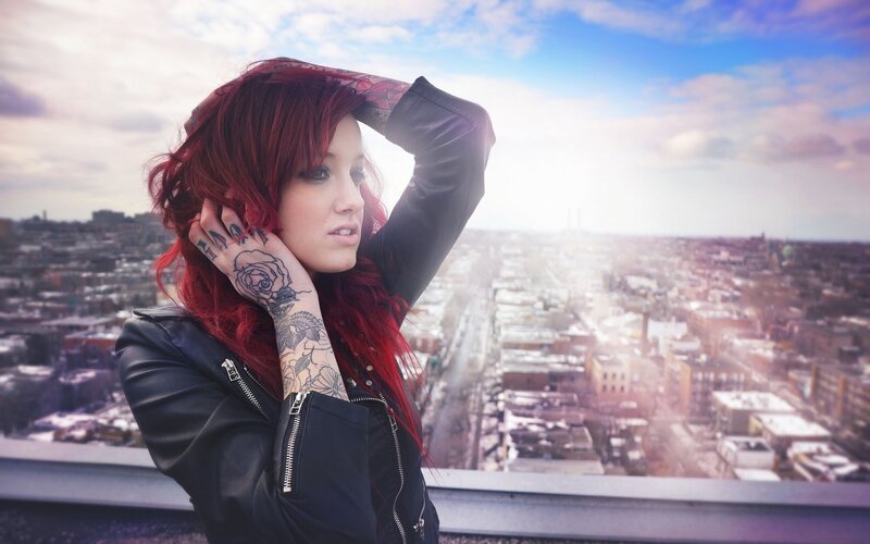 woman with red hair on rooftop