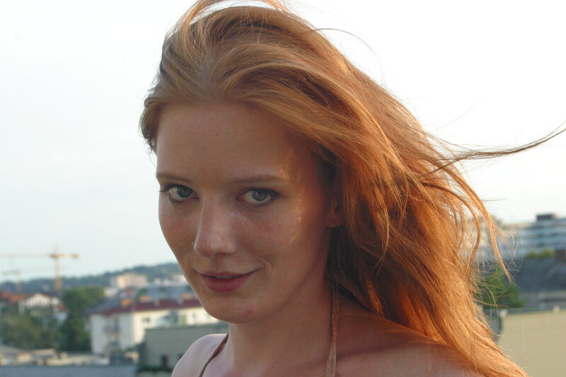 woman with red hair on rooftop