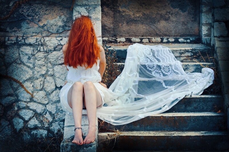 Woman with red hair on steps