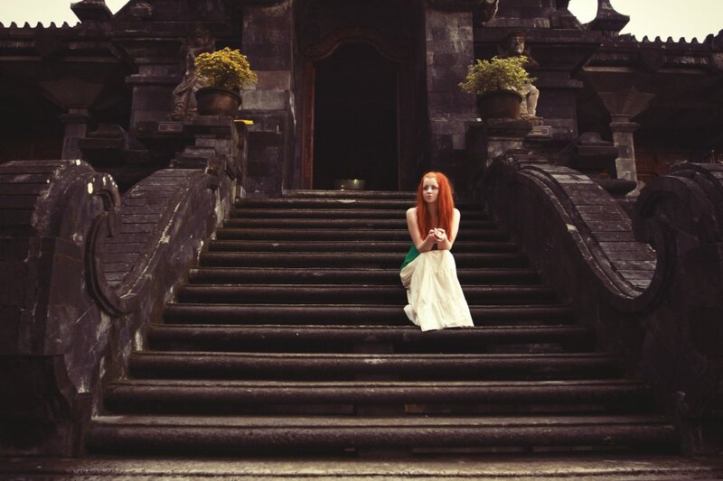 Woman with red hair on temple steps