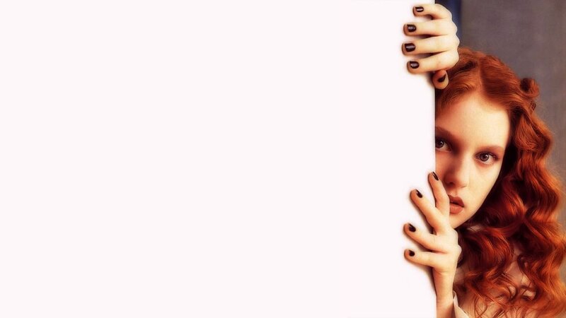 woman with red hair peeking