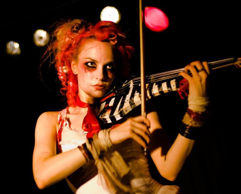 Woman with red hair playing violin