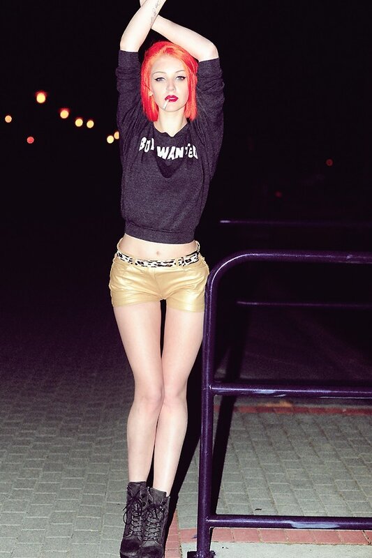 woman with red hair posing at night