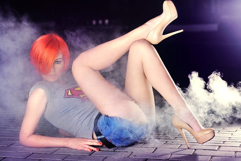 woman with red hair posing on ground