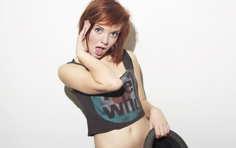 woman with red hair posing playfully