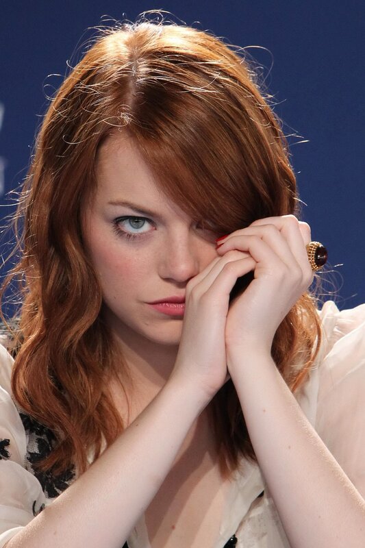 woman with red hair resting hands