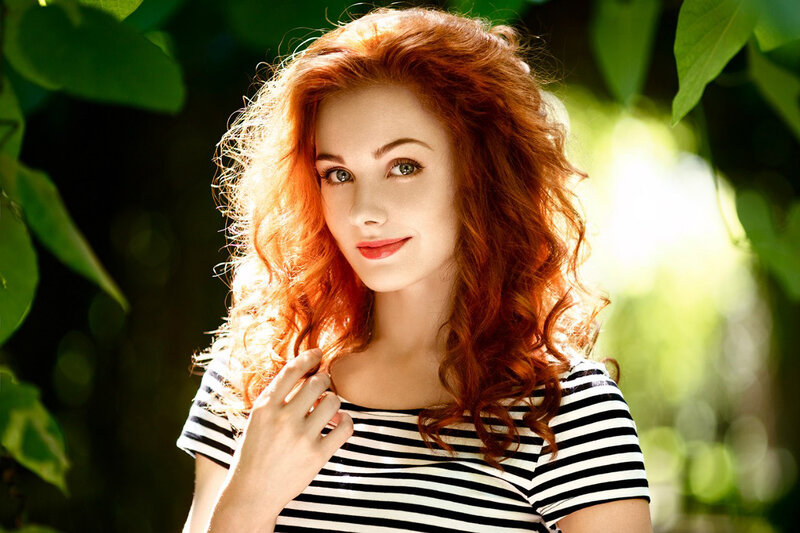 Woman with Red Hair — Serene, Afternoon, Photograph, Striped Shirt, Green Leaves