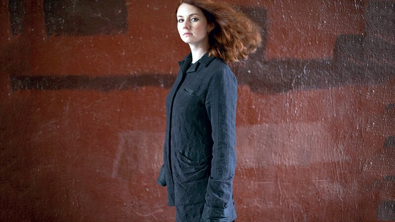 Woman with Red Hair — Serious, Photograph, Red Wall