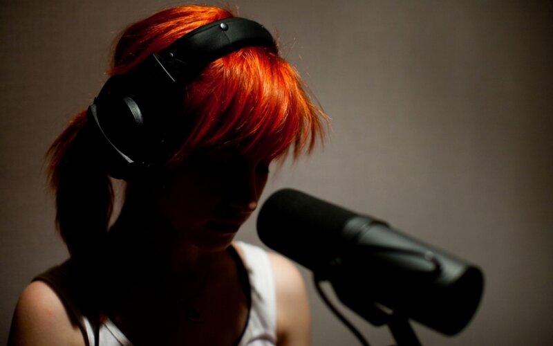 woman with red hair singing