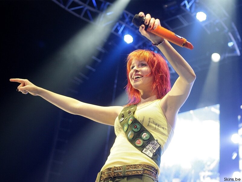 Woman with Red Hair Singing — Energetic, Night, Photograph, Microphone, Stage Lights, Sweater Vest