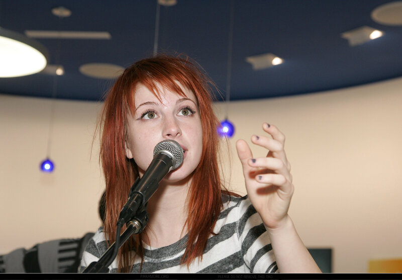Woman with Red Hair Singing — Focused