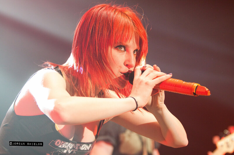 Woman with Red Hair Singing — Intense, Photograph, Microphone, Stage Light