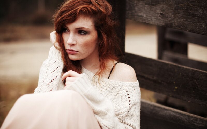woman with red hair sitting