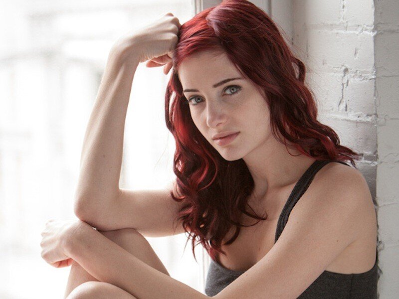 woman with red hair sitting