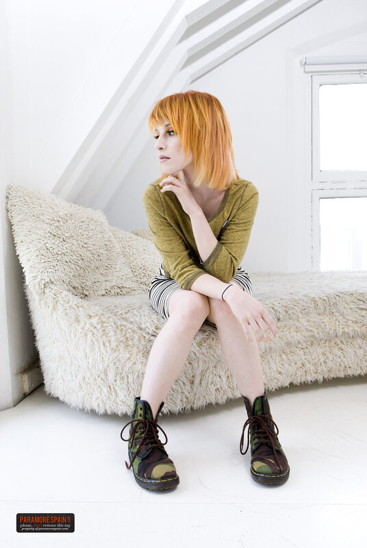 woman with red hair sitting on a sofa