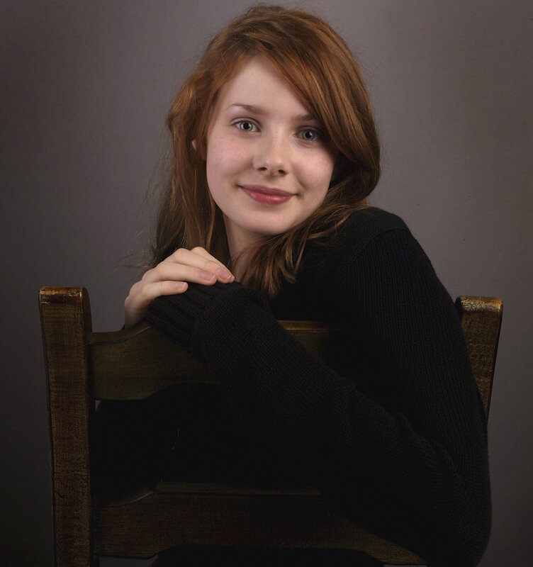 woman with red hair sitting on chair