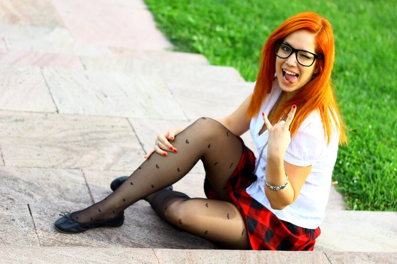 woman with red hair sitting on steps