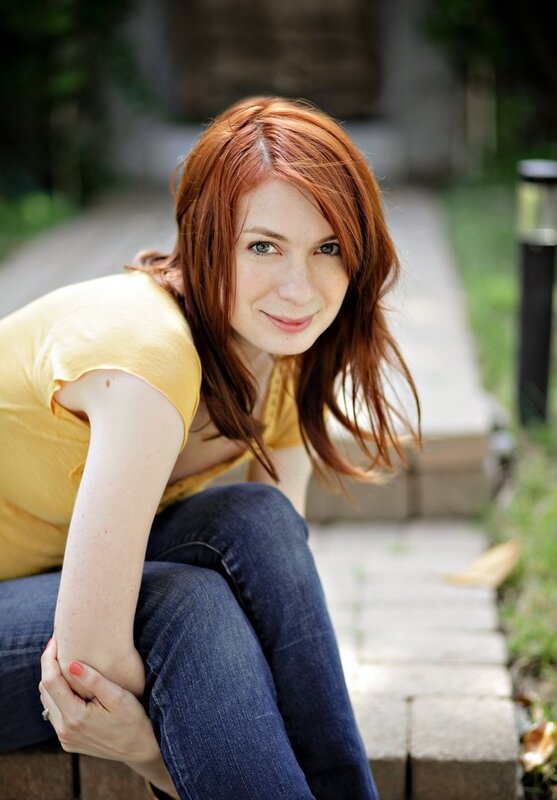 woman with red hair sitting outside