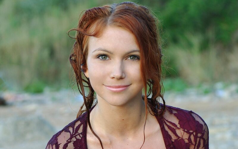 woman with red hair smiling