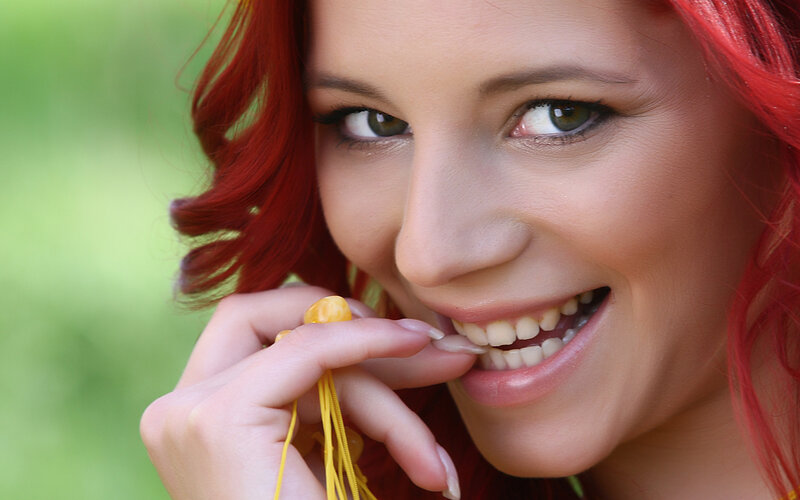 woman with red hair smiling