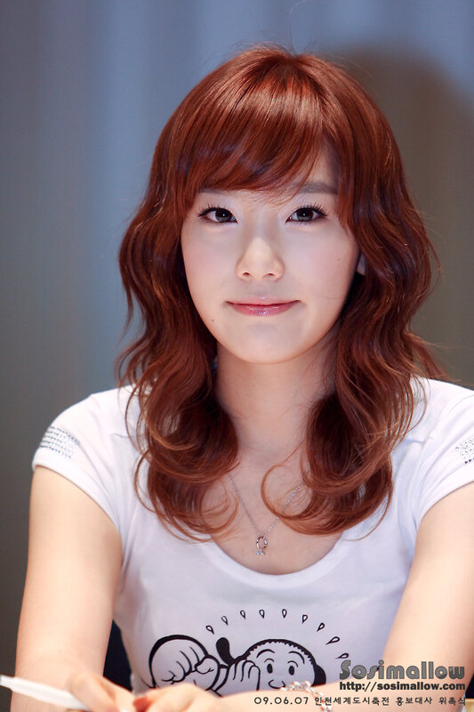 woman with red hair smiling